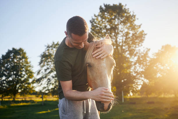 istock Man embracing of therapy horse 1674209781
