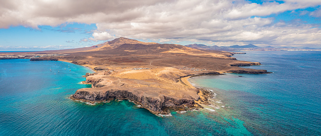 Aerial photo from a drone of some popular tourist beaches along the South Coast of Lanzarote near Playa Blanca. Included beaches are Playa Mujeres, Playa Del Pozo, Playa de La Cera and Playa de Papagayo. This is the most southern point of the island 'Punta del Papagayo. Images captured in September 2023.