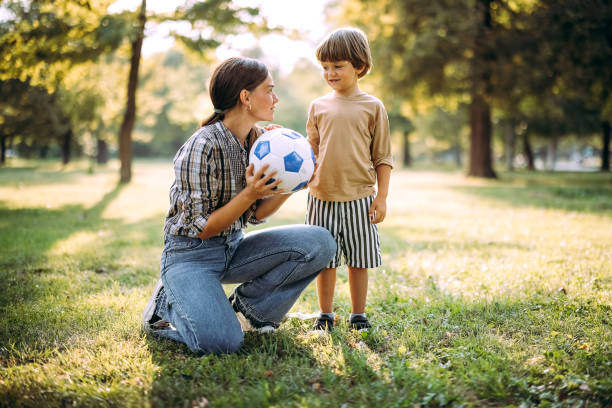 istock Mother and son play together 1674211400