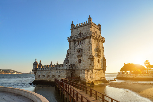 View at the Belem tower or Torre de Belem of Portuguese Manueline style on the northern bank of the Tagus River at sunset in Lisbon, Portugal