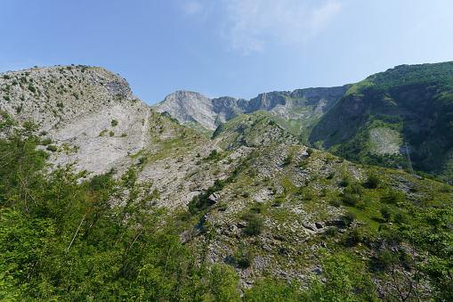 Summer scene in high mountains, rocks with high peaks in background