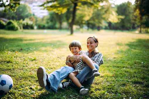 Mother and son play together in the park