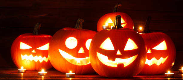 istock Three Halloween Pumpkins and candles 1674244471