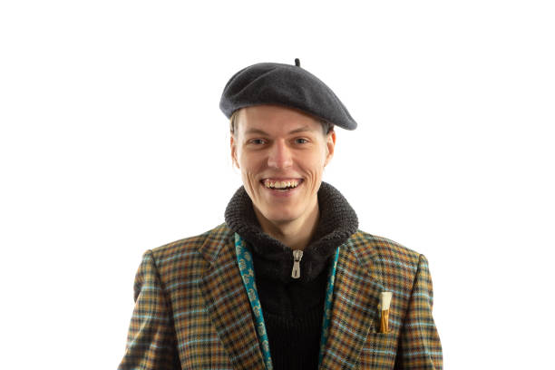 Young smiling artist with a beret on his head on a white background