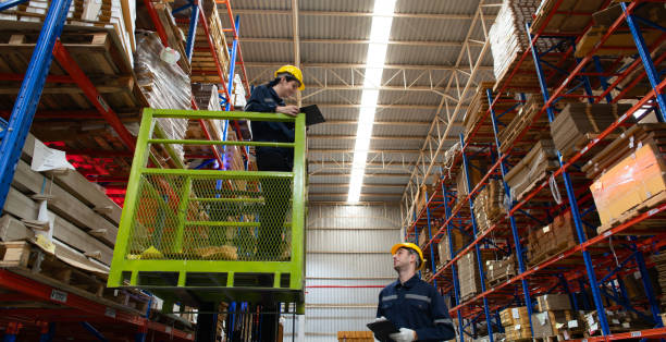 istock Warehouse workers using forklift to check and counting in a large warehouse. This is a large paper package storage and distribution warehouse. 1674271685