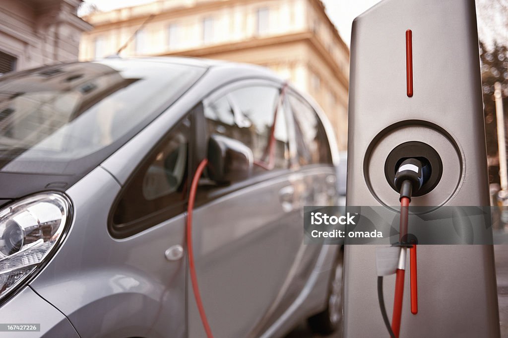 Electric car in charging An electric car in charging on the street Electric Car Stock Photo
