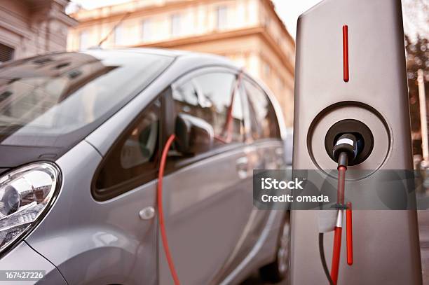 Electric Car In Charging Stock Photo - Download Image Now - Electric Car, Electric Vehicle, Electric Vehicle Charging Station