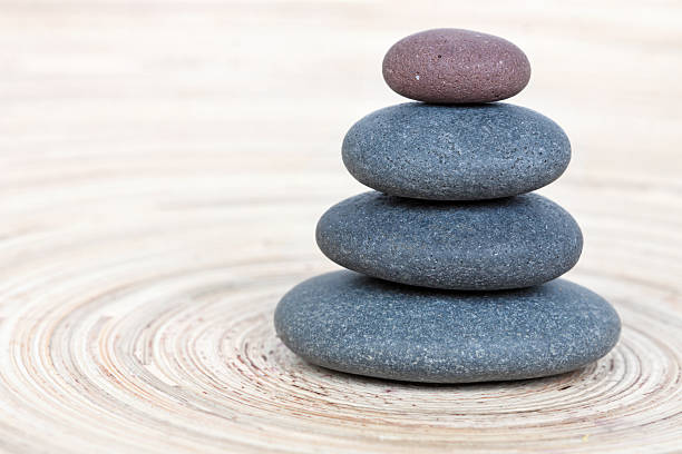 istock Balancing of pebbles on wooden background 167427417