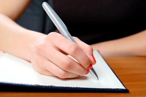 Young woman writing in office