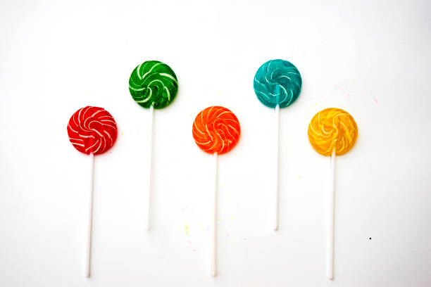 Colorful candies and lollipops with stick isolated on white background