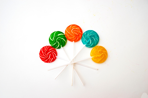 multicolored, different sweets, lollipops on a white background. Copy space. Top view, sweets concept