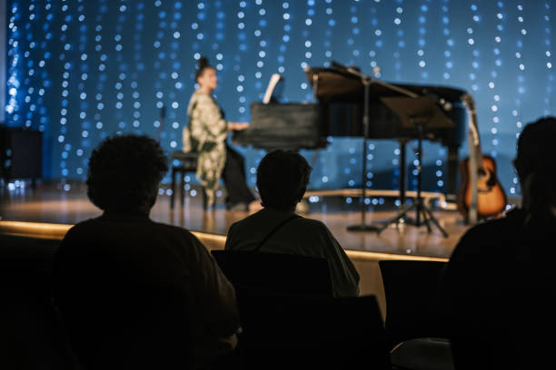 istock Senior woman playing piano on the stage 1674278452