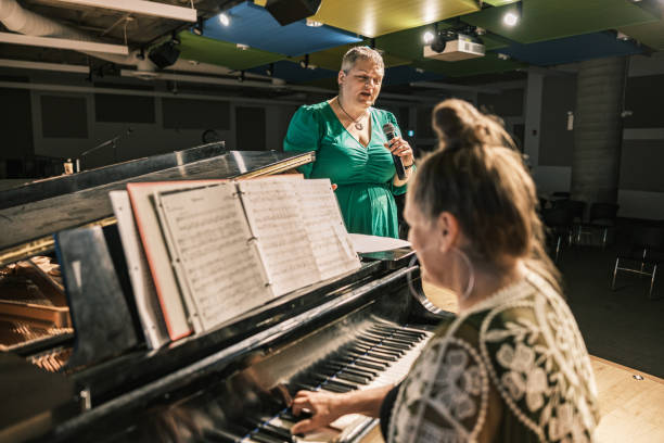istock Two mature women performing music on stage 1674280002
