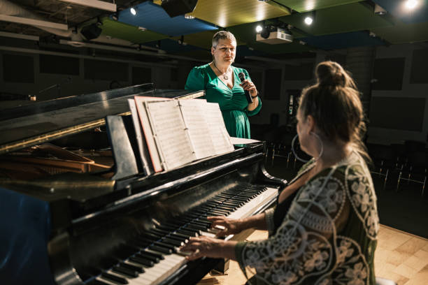 istock Two mature women performing music on stage 1674280100