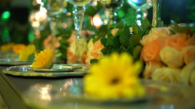 wedding decoration with yellow flowers and green foliage