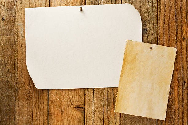 istock mottled beige paper nailed to distressed wooden wall 167429241