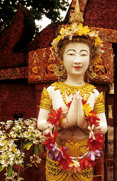 istock Thailand, Chiang Mai, Buddhist temple, greeting statue with flowers. 167430573