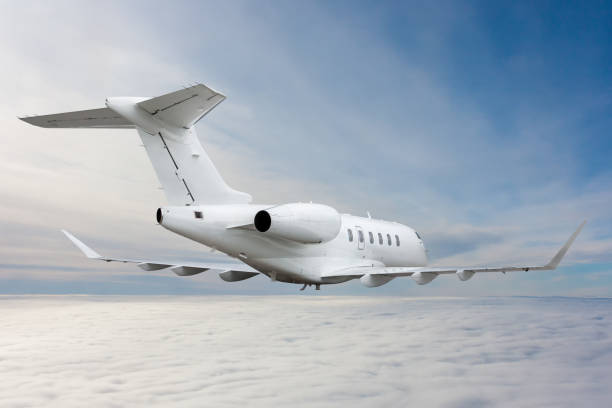 istock White luxury private jet flying in the air above the clouds 1674324094