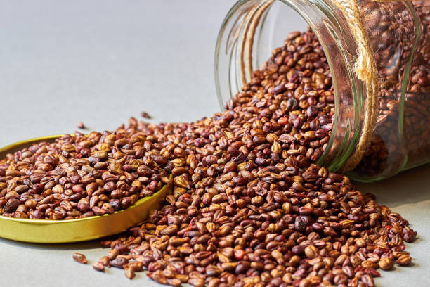 istock Close up with dried grape seeds scattered from glass jar 1674330066