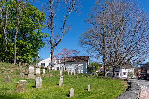 Bedford, NY, USA-May 2022; View along the main road through town with on left hand side the Old Bedford Cemetery, also known as Old Burying Ground
