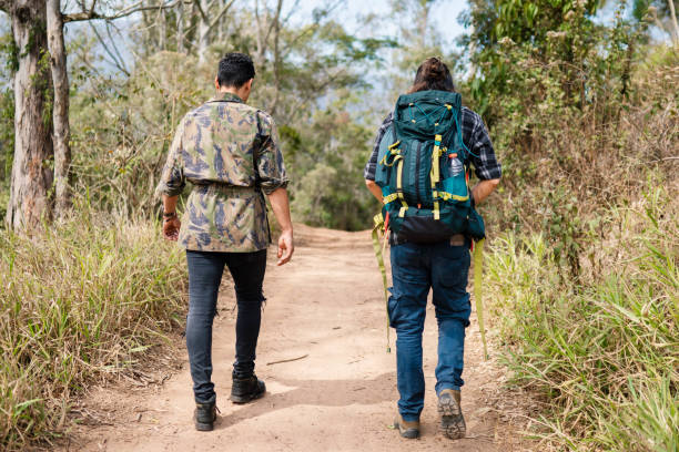 istock Two young men hiking along a trail in the summer 1674344839
