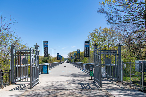 Poughkeepsie, NY, USA-May 2022; View entrance gate for the 1.28 miles Walkway Over the Hudson State Historic Park Bridge from 1889, part of the Hudson Valley Rail Trail