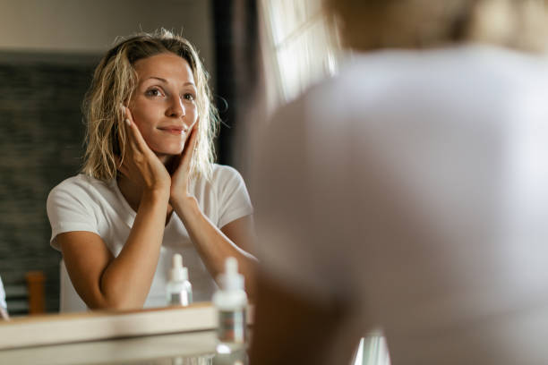 istock Young woman taking care for her face in bathroom 1674357705