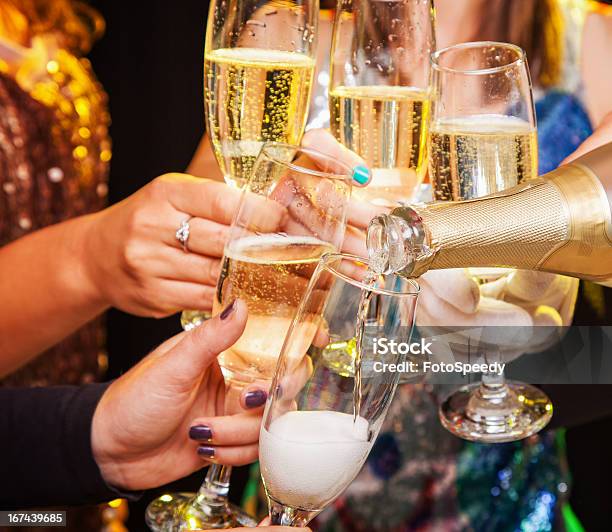 Hands Holding Champagne Glasses During A Toast Stock Photo - Download Image Now - Champagne, Party - Social Event, Celebratory Toast