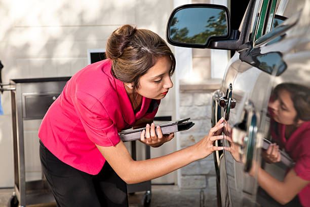 Automobile insurance adjuster inspecting damage to vehicle Insurance adjuster inspecting damage to vehicle.  insurance agent photos stock pictures, royalty-free photos & images