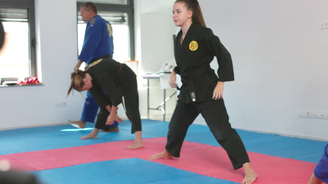 Group Of Children Do Warm Up Exercises Before Aikido Training