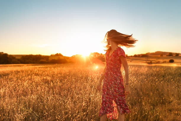 istock Woman in the field at sunset. 1674402757