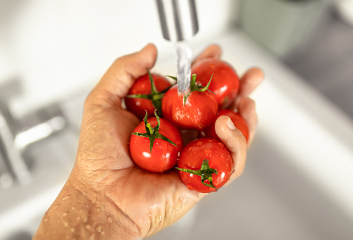 Washing tomatoes.