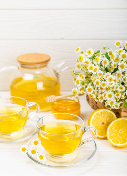 istock Chamomile tea in a  cup on a texture background. Natural hour with chamomile flowers. Herbal tea. Immunity tea.Natural healer concept. Healthy detox drink.Close up. Place for text. 1674409402