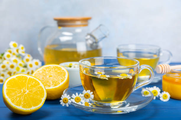 istock Chamomile tea in a  cup on a texture background. Natural hour with chamomile flowers. Herbal tea. Immunity tea.Natural healer concept. Healthy detox drink.Close up. Place for text. 1674409417