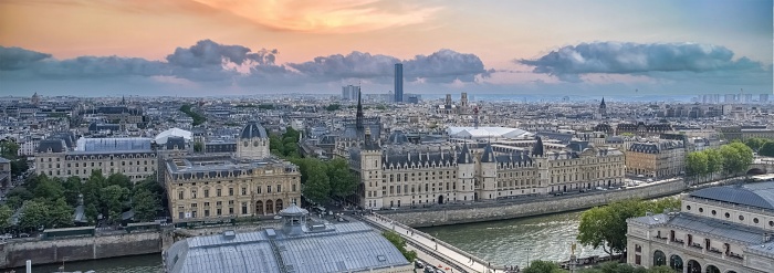 A panoramic view of a sunset sky over the historic skyline of Paris, France