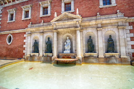 Fountain at Plaza del Colegio del Patriarca rear facade of building at University of Valencia, Spain