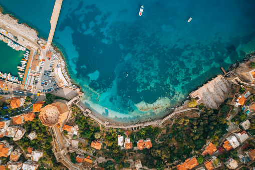 Beautiful panoramic view of Assos village with vivid colorful houses near blue turquoise colored and transparent bay lagoon. Kefalonia, Greece.