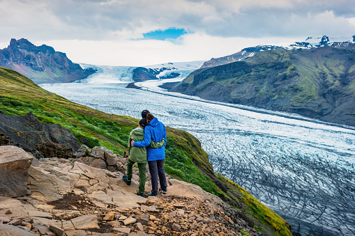 Mother and son enjoy the view at Skaftafell Glacier in Skaftafell National Park, Iceland
