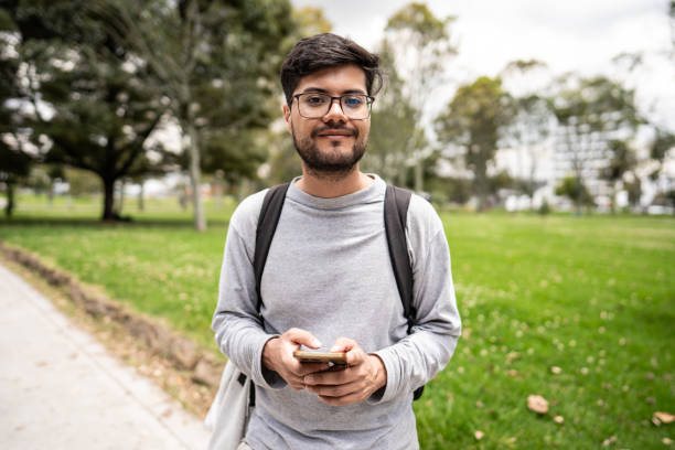 istock Portrait of a young man using mobile phone on the public park 1674439984