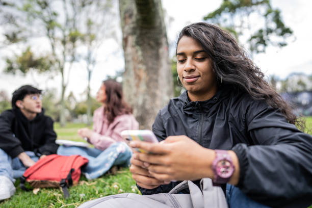 istock Young woman using mobile phone on the public park 1674441089
