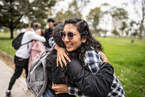 Young friends greeting each other on the public park