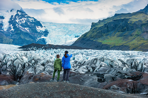 Mother and son look at Svinafellsjokull Glacier in Skaftafell National Park, Iceland