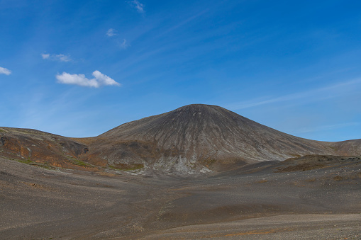 Panoramic view over volcanic landscape on Reykjanes Peninsula, Iceland, near sites of 2021 and 2022 eruptions near mountain Fagradalsfjall volcano area against a white clouded blue sky