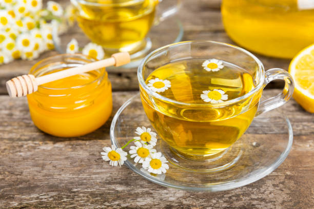 istock Chamomile tea in a  cup on a texture background. Natural hour with chamomile flowers. Herbal tea. Immunity tea.Natural healer concept. Healthy detox drink.Close up. Place for text. 1674471663