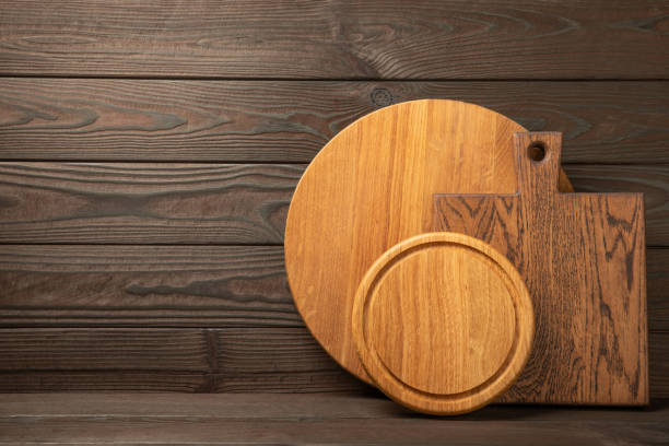 istock Cutting board on  textured table. Kitchen wooden cutting board. Kitchenware. Menu. Recipe. The concept of cooking. Mocap. Place for text. copy space. 1674472202