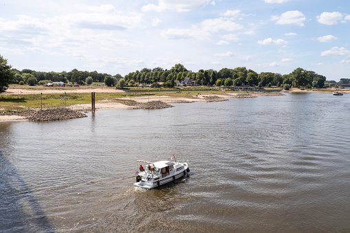 Deventer, Netherlands, August 7, 2022; Pleasure yacht sails on the river IJssel near Deventer.