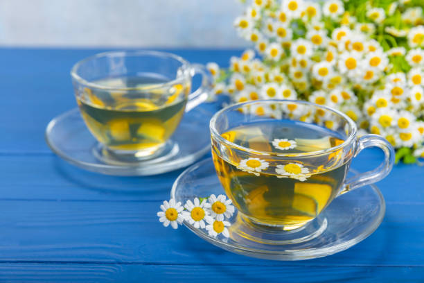 istock Chamomile tea in a  cup on a texture background. Natural hour with chamomile flowers. Herbal tea. Immunity tea.Natural healer concept. Healthy detox drink.Close up. Place for text. 1674485463