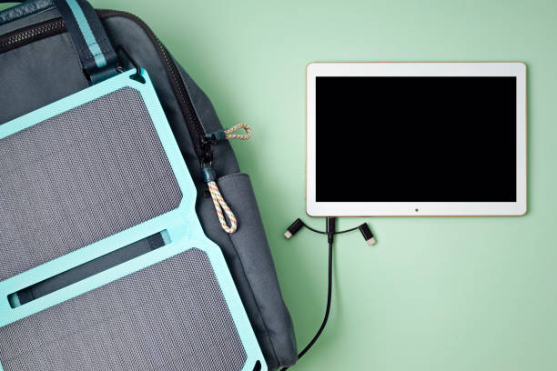 Men connected charger to tablet computer after four digital devices already charging