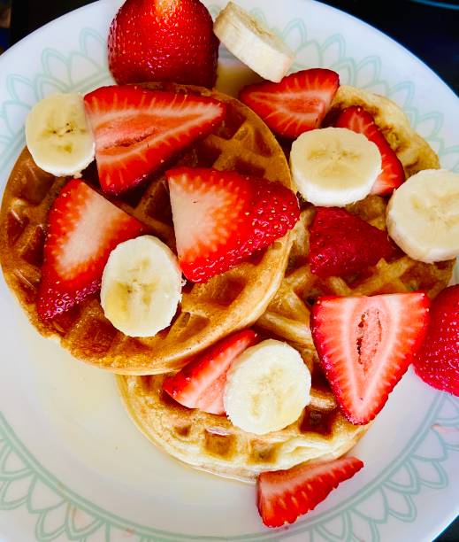 Waffles with strawberries, bananas and maple syrup