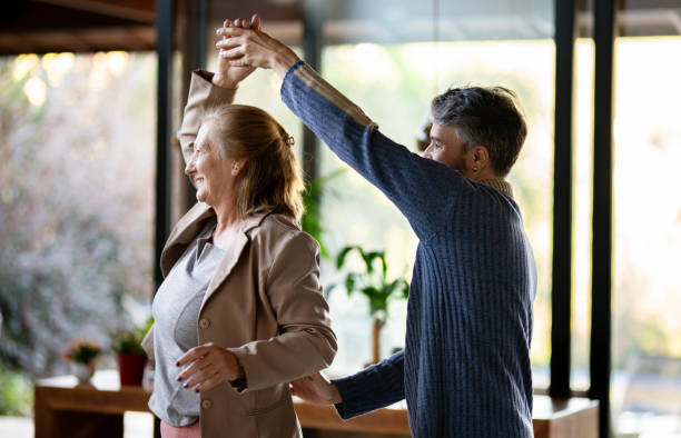 istock Man dancing with his senior mom during a visit 1674489648